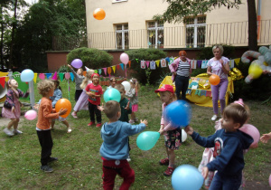 dzieci w ogrodzie przedszkolnym podczas zabawy urodzinkowej z balonami