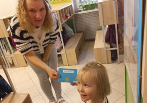 Dziewczynka wręcza zaproszenie Pani Kasi.