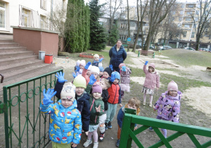 Grupa dzieci stoi w przejściu na plac zabaw.