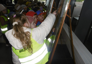 Dzieci ogladają zdjęcia w Porcie Lotniczym.