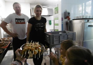 Dzieci częstują pana kucharza i panią z obsługi.