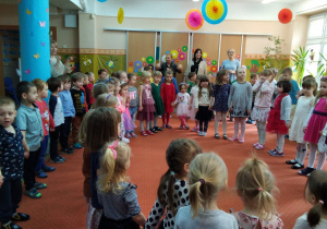 wspólne śpiewanie posenki na sali gimnastycznej - dzieci ustawione w kole