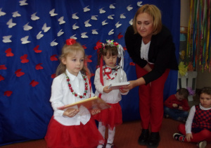 dziewczynki otrzymują nagrody książkowe