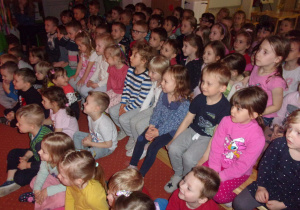 dzieci na ławeczkach na sali gimnastycznej